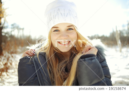 portrait of a young blonde girl in winter forest in the park portrait of a young blonde girl in winter forest in the park 19158674