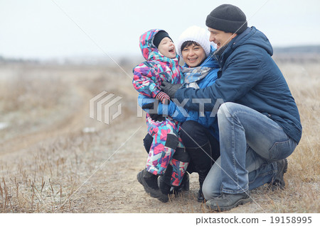 young family with a child playing on winter field young family with a child playing on winter field 19158995