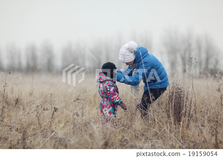 mother with a small child winter outdoors mother with a small child winter outdoors 19159054