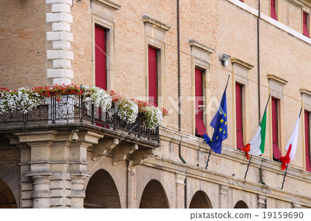 Facade of Rimini City Hall with flags and flowers  19159690