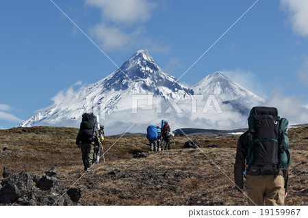 Hikers trekking in mountain on background volcanos 19159967
