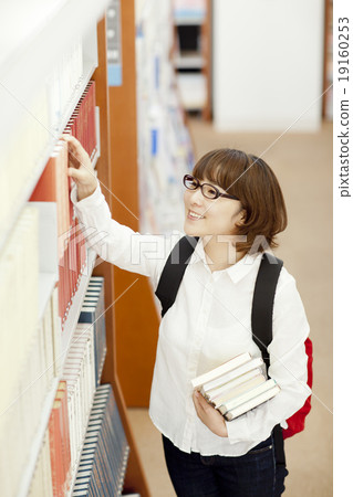 A woman looking for a book 19160253