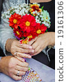 hands in close-up shot rings flowers elderly 19161306