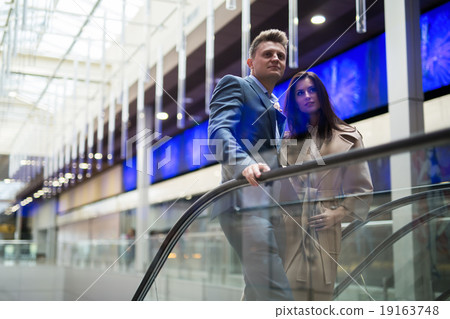 Woman in trench coat and a man 19163748