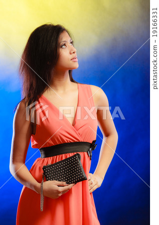 Elegant woman in dress holds handbag Elegant woman in dress holds handbag 19166331