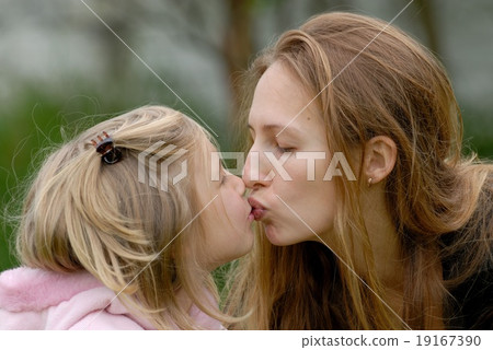 Girl and mom are kissing. 19167390