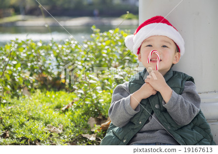 Cute Mixed Race Boy With Santa Hat and Candy Cane 19167613