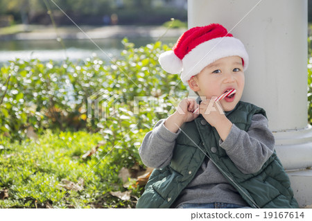 Cute Mixed Race Boy With Santa Hat and Candy Cane 19167614