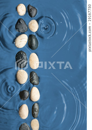 Black and white stones in the water under the rain 19167780
