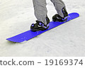 sportsman with blue snowboard on white snow. 19169374