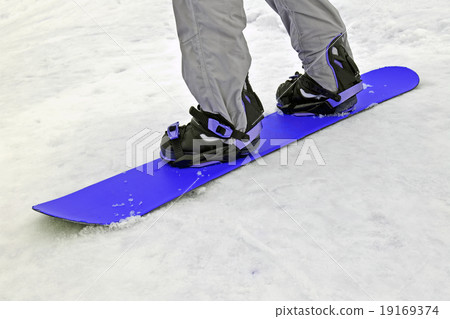 sportsman with blue snowboard on white snow. 19169374