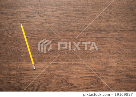 yellow pencil on wooden background yellow pencil on wooden background 19169857