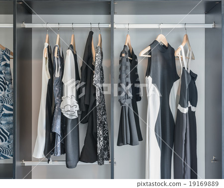 black and white clothes hanging in closet black and white clothes hanging in closet 19169889