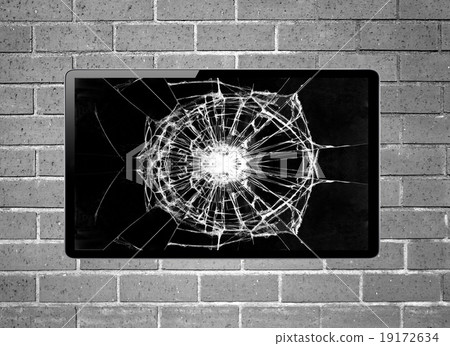 Blank screen TV with broken screen hanging on wall 19172634