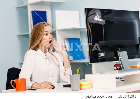 Woman sitting at the desk  with computer 19174295