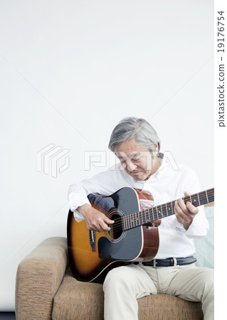 A girl playing a guitar in his 60's 19176754
