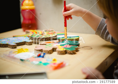 Little female baby painting with colorful paints 19177589