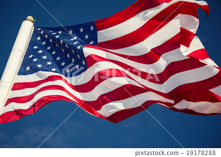 American flag over blue sky 19178288