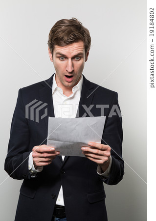 studio shot of businessman with sheet of paper 19184802