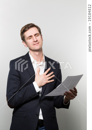 studio shot of businessman with sheet of paper studio shot of businessman with sheet of paper 19184812