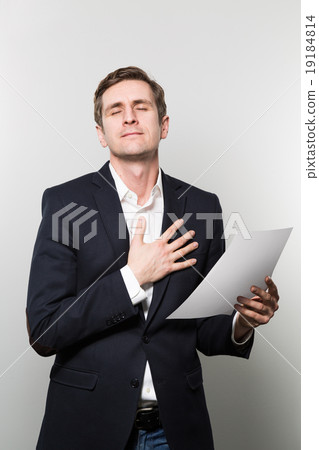 studio shot of businessman with sheet of paper studio shot of businessman with sheet of paper 19184814