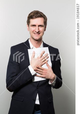 studio shot of businessman with sheet of paper studio shot of businessman with sheet of paper 19184817
