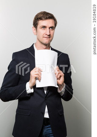studio shot of businessman with sheet of paper studio shot of businessman with sheet of paper 19184819