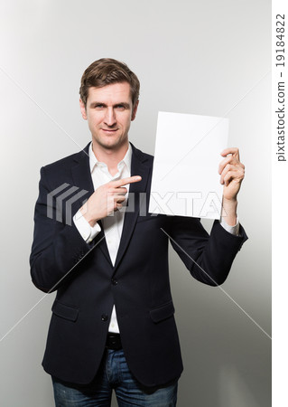 studio shot of businessman with sheet of paper studio shot of businessman with sheet of paper 19184822