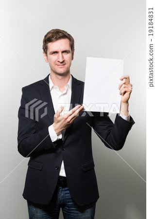 studio shot of businessman with sheet of paper studio shot of businessman with sheet of paper 19184831
