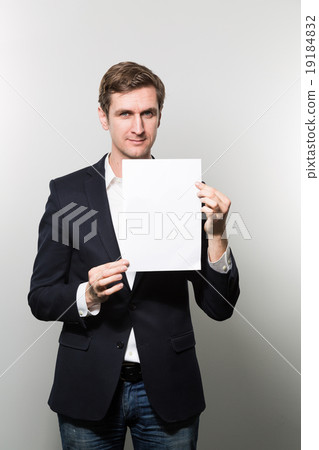 studio shot of businessman with sheet of paper studio shot of businessman with sheet of paper 19184832