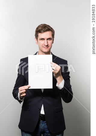 studio shot of businessman with sheet of paper studio shot of businessman with sheet of paper 19184833