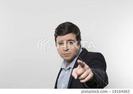 studio shot of happy businessman pointing at camera 19184865