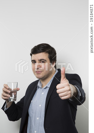 studio shot of happy businessman drinking water 19184871