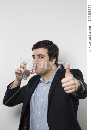 studio shot of happy businessman drinking water studio shot of happy businessman drinking water 19184872