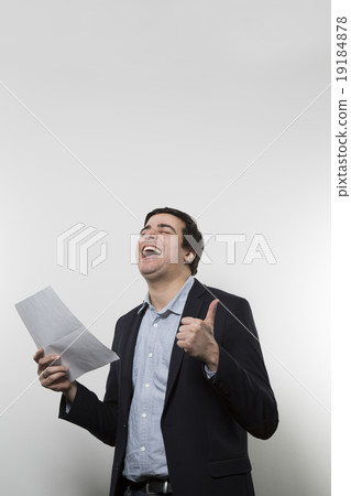 studio shot of happy businessman celebrating a paper 19184878