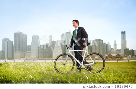 Business Man Pushing Bike Outdoors Concept 19189473