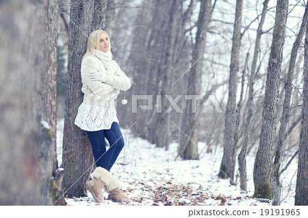 young beautiful blonde girl in winter forest 19191965