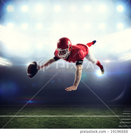 Composite image of american football player reaching football 19196888