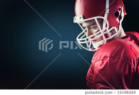 Composite image of concentrated american football player 19196889