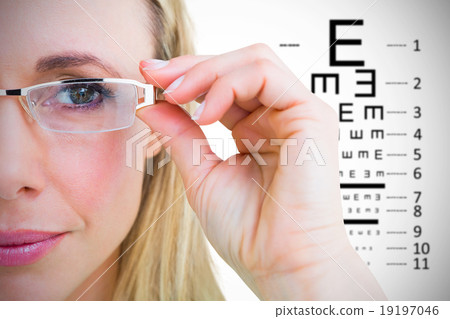 Composite image of close up of pretty blonde with reading glasse 19197046