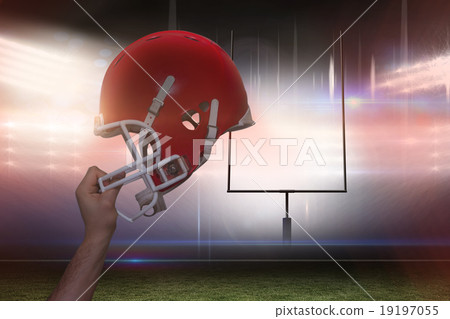 Composite image of american football player handing his helmet Composite image of american football player handing his helmet 19197055