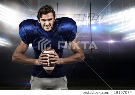 Composite image of aggressive american football player holding b Composite image of aggressive american football player holding b 19197074