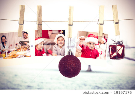 Composite image of hanging christmas photos 19197176