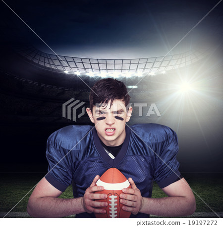 Composite image of enraged american football player holding a ba Composite image of enraged american football player holding a ba 19197272