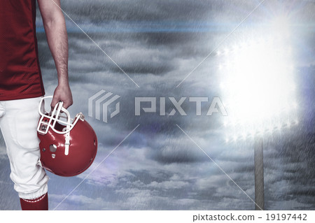 Composite image of american football player holding an helmet Composite image of american football player holding an helmet 19197442