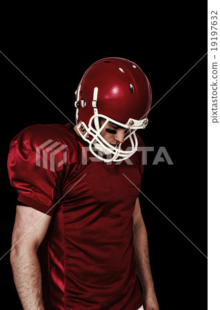 Composite image of unsmiling american football player looking do 19197632