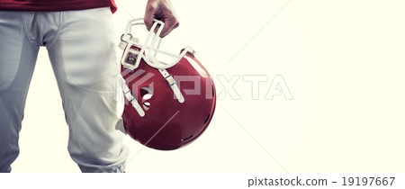 Composite image of an american football player taking his helmet 19197667
