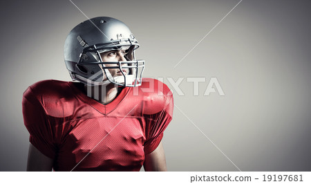 Composite image of american football player looking away while s Composite image of american football player looking away while s 19197681
