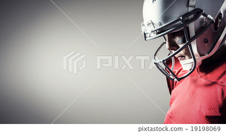Composite image of american footballer looking down 19198069