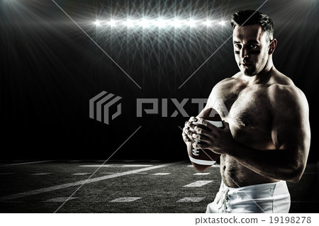 Composite image of shirtless american football player with ball 19198278